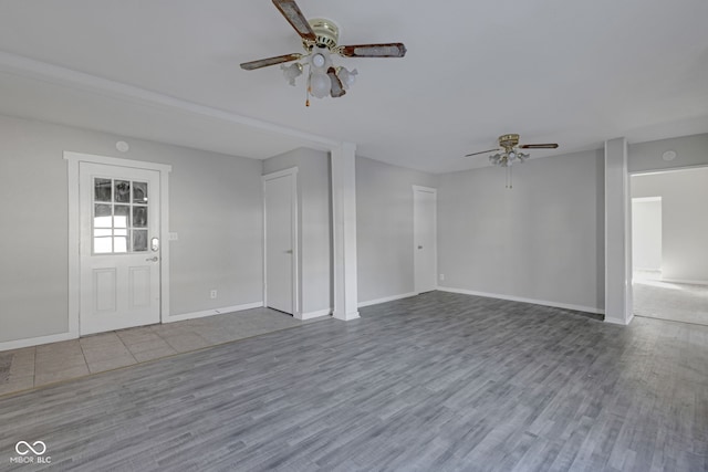 unfurnished living room featuring hardwood / wood-style flooring and ceiling fan