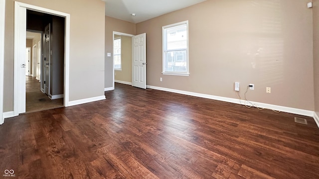 spare room with dark wood-type flooring