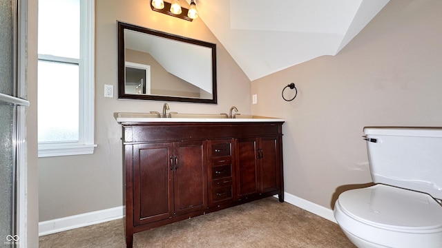 bathroom featuring lofted ceiling, vanity, and toilet