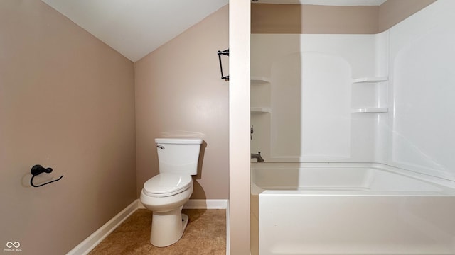 bathroom featuring toilet, tile patterned flooring, and vaulted ceiling