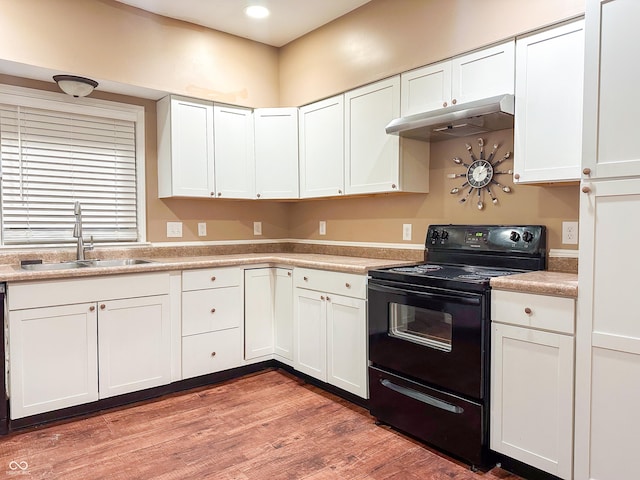 kitchen featuring white cabinetry, wood-type flooring, black electric range oven, and sink