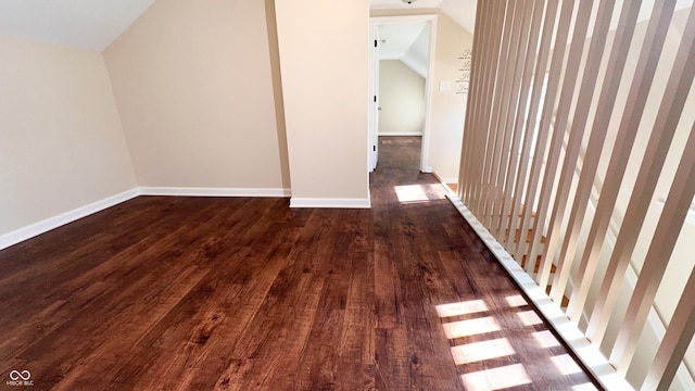 bonus room featuring dark hardwood / wood-style flooring and lofted ceiling