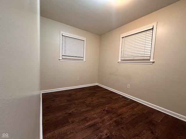 spare room featuring dark hardwood / wood-style flooring