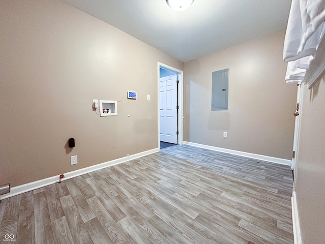 clothes washing area featuring washer hookup, electric panel, and light wood-type flooring