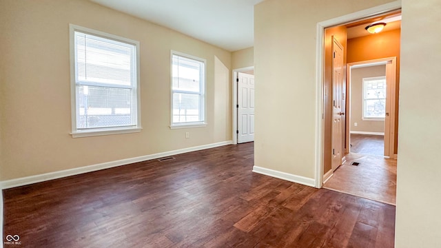 spare room featuring dark wood-type flooring