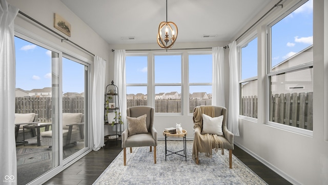 sunroom featuring a chandelier