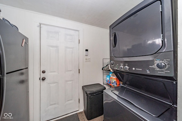 laundry area with stacked washer and dryer