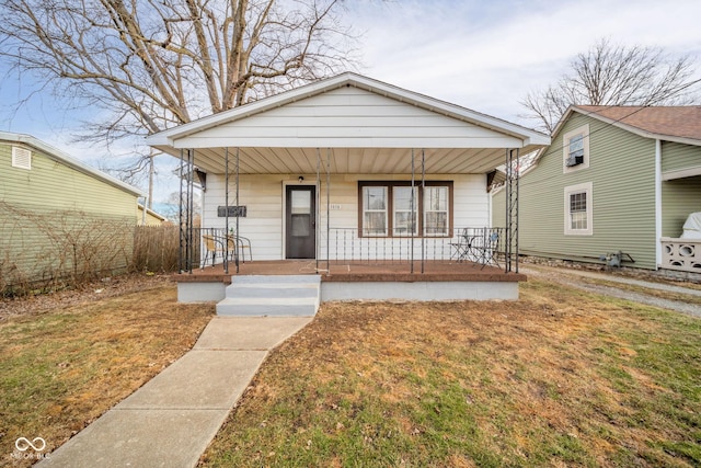 bungalow-style house featuring a front lawn and a porch