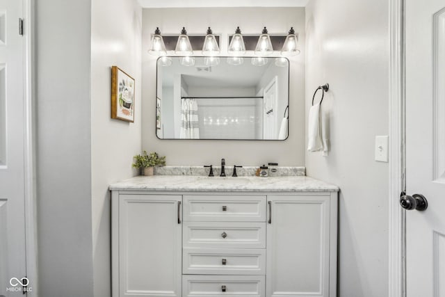 bathroom featuring vanity and curtained shower