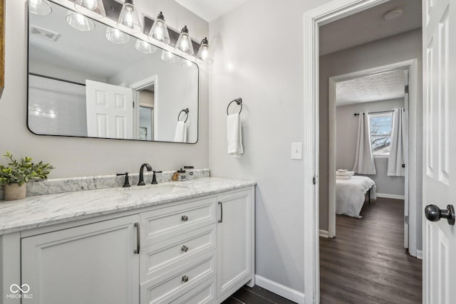 bathroom with hardwood / wood-style flooring and vanity