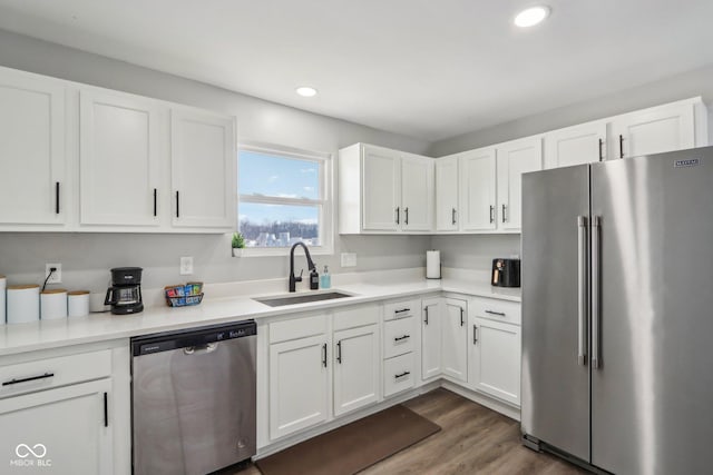 kitchen with white cabinetry, stainless steel appliances, dark hardwood / wood-style flooring, and sink