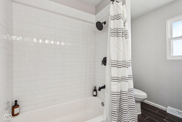 bathroom with shower / tub combo with curtain and toilet