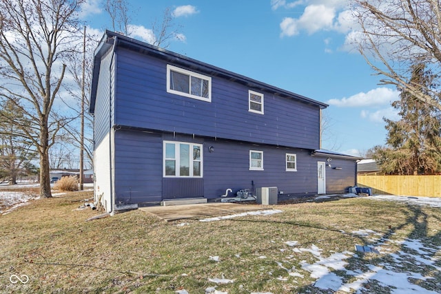 rear view of house with central AC unit, a yard, and a patio