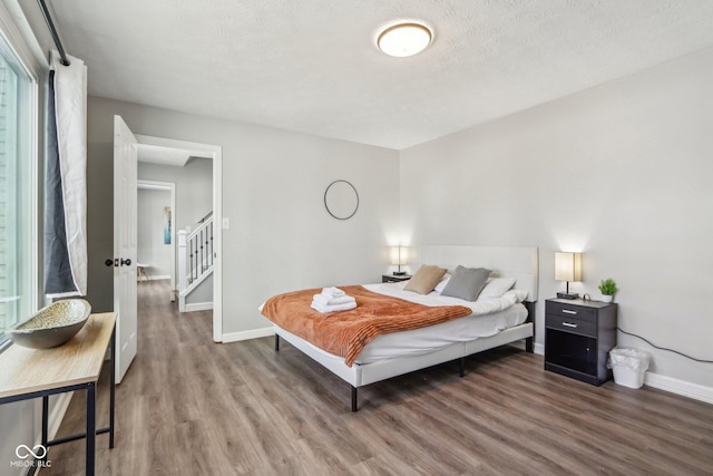 bedroom featuring hardwood / wood-style floors and a textured ceiling