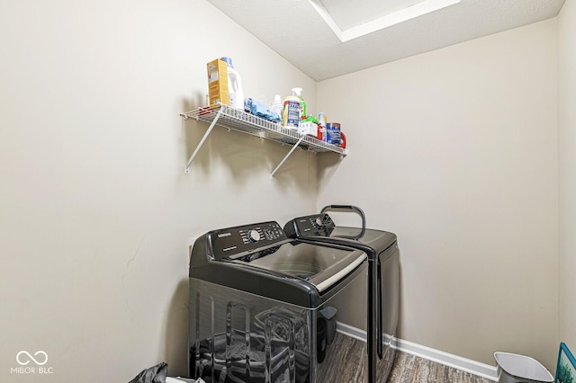 laundry area featuring washing machine and dryer and dark wood-type flooring