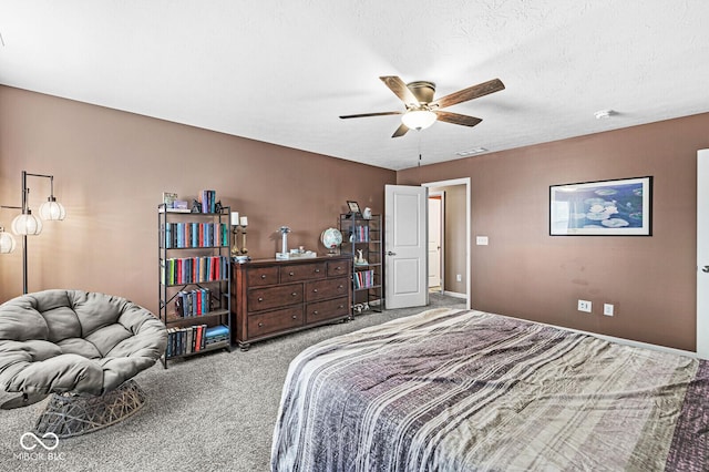 bedroom featuring ceiling fan, carpet floors, and a textured ceiling