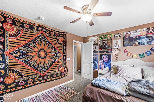 carpeted bedroom featuring ceiling fan and a textured ceiling