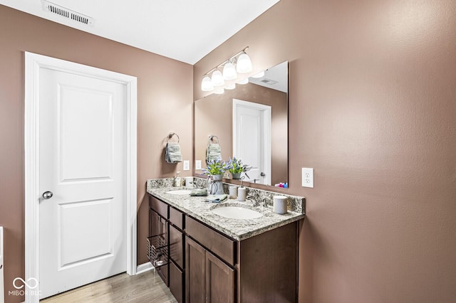 bathroom with vanity and hardwood / wood-style floors