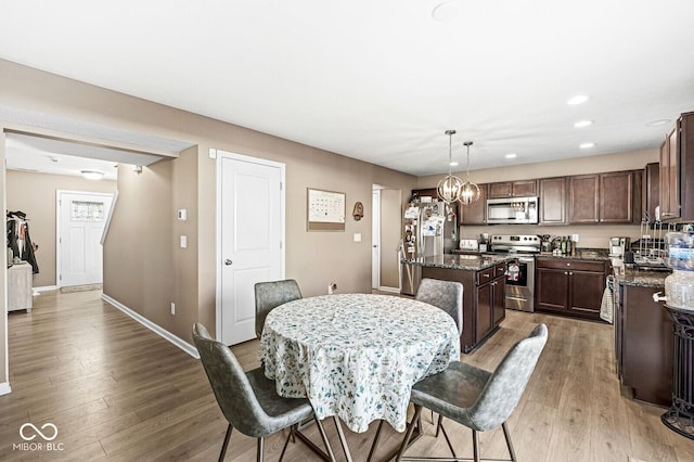 dining room featuring dark hardwood / wood-style flooring and an inviting chandelier