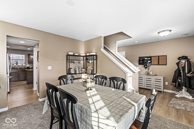 dining space with dark hardwood / wood-style floors