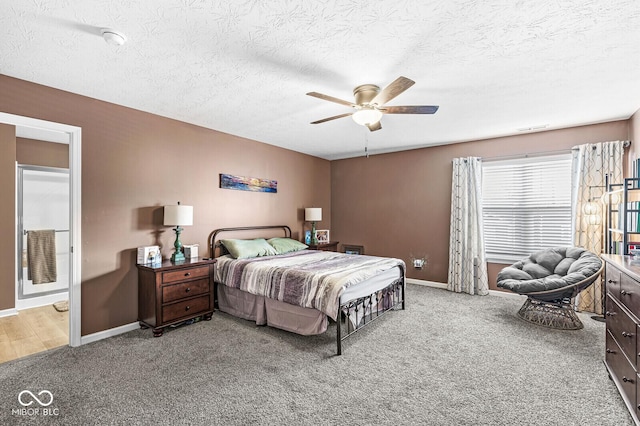 bedroom featuring carpet, a textured ceiling, and ceiling fan