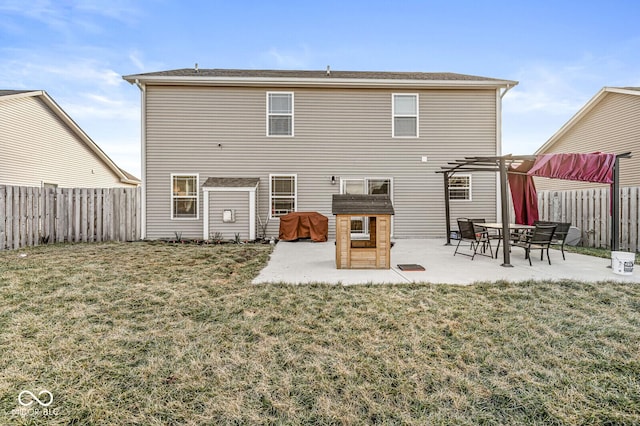 rear view of house featuring a yard, a pergola, and a patio area