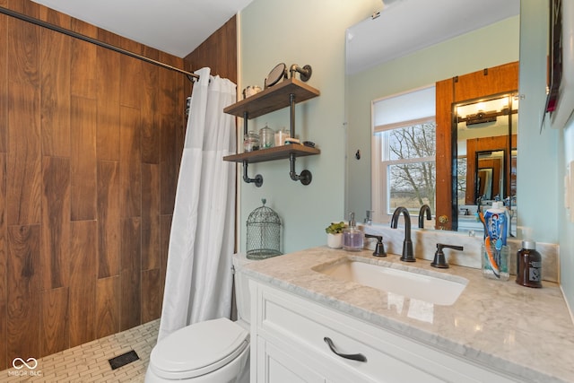 bathroom with vanity, toilet, and walk in shower