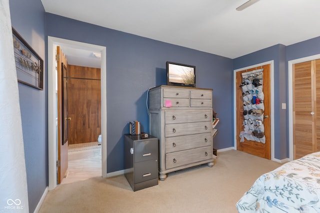 bedroom featuring light carpet and ensuite bath