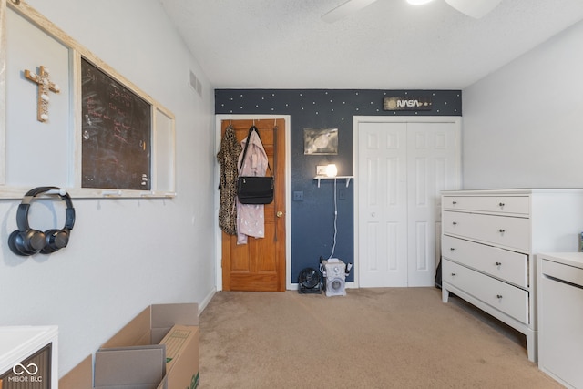 bedroom with ceiling fan, a closet, and light carpet