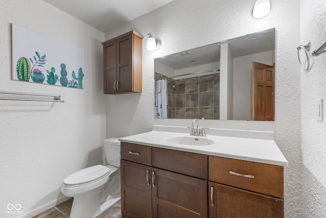 bathroom featuring vanity, curtained shower, and toilet