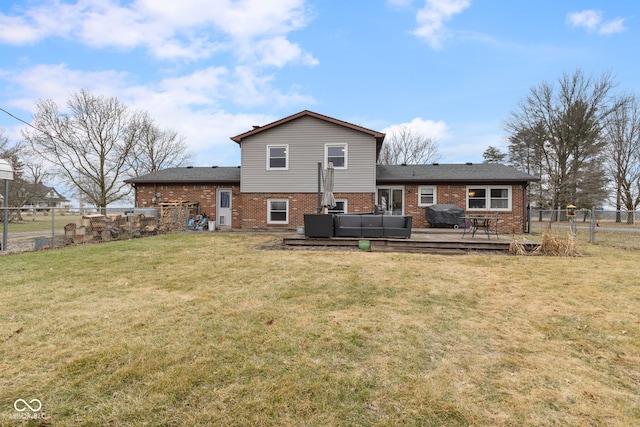 rear view of house featuring a wooden deck, a yard, and outdoor lounge area