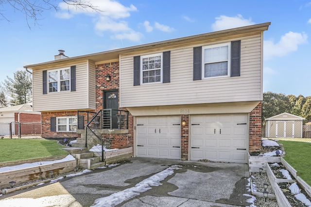 bi-level home with a garage and a front lawn