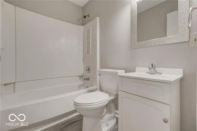 full bathroom featuring hardwood / wood-style flooring, vanity, bathtub / shower combination, and toilet