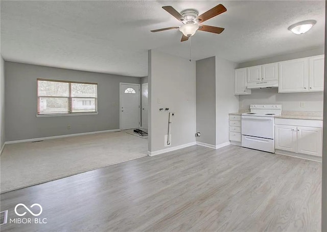 kitchen with white cabinetry, light hardwood / wood-style floors, a textured ceiling, and white range with electric stovetop