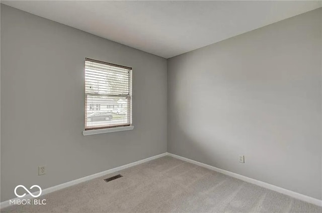 spare room with light colored carpet