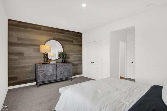 bedroom featuring carpet and wood walls