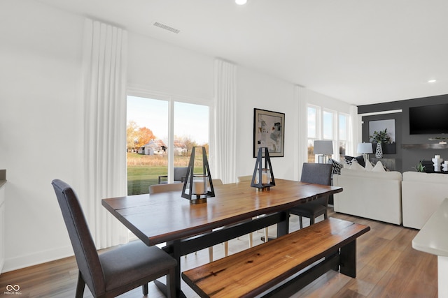 dining space with hardwood / wood-style floors