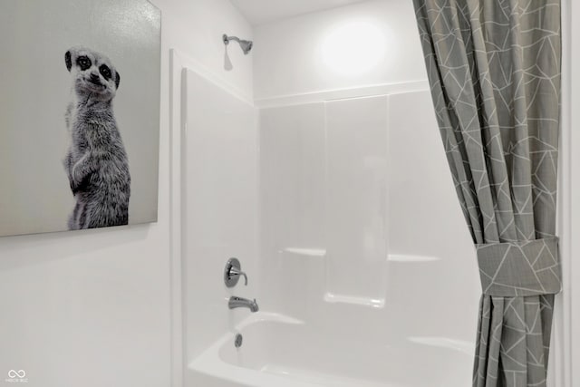 bathroom with shower / bath combo with shower curtain