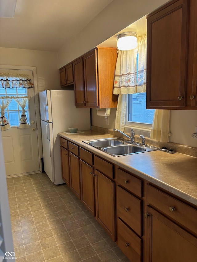 kitchen featuring white refrigerator and sink