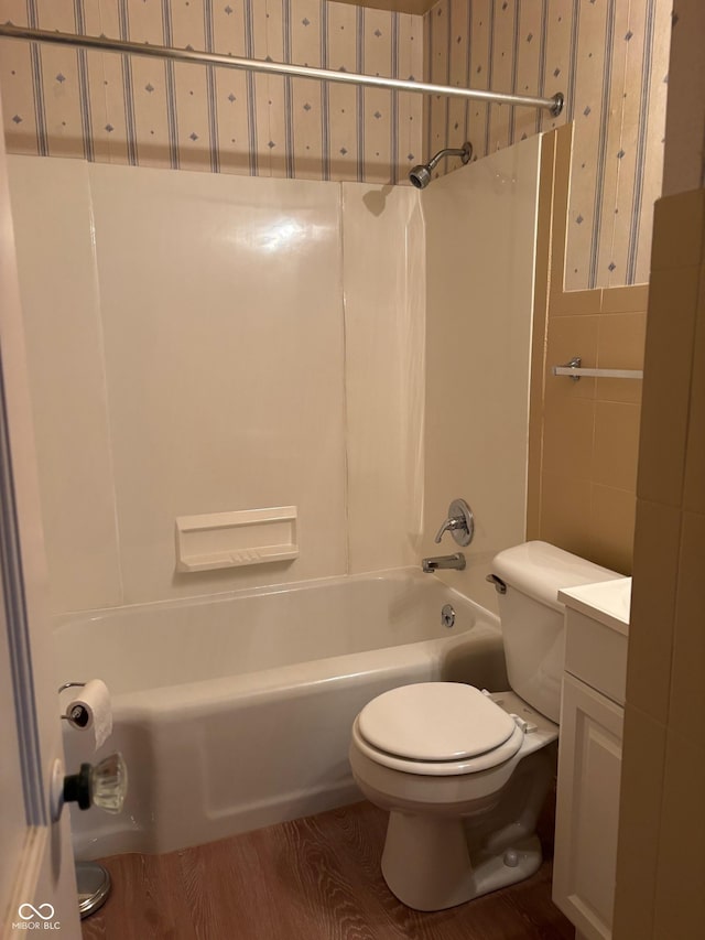 full bathroom with vanity, toilet, hardwood / wood-style floors, and shower / bathing tub combination