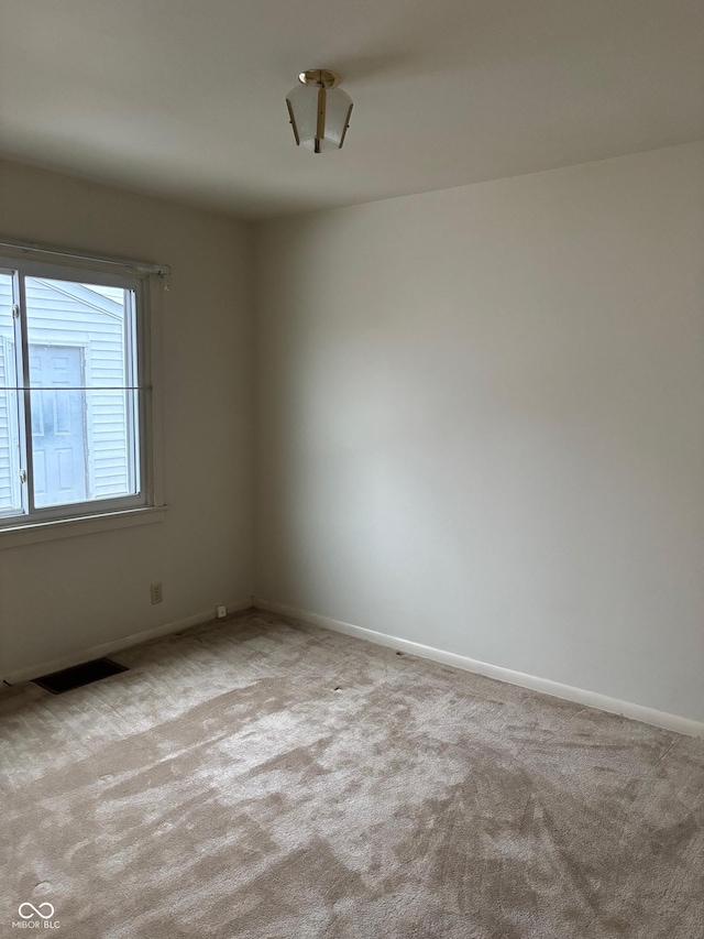 unfurnished room featuring light colored carpet