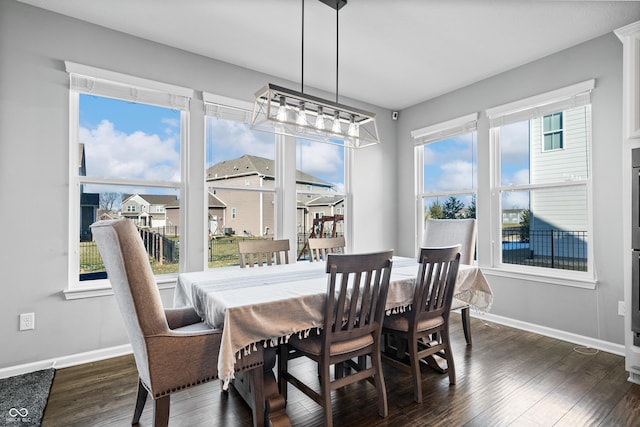 dining space with dark hardwood / wood-style flooring