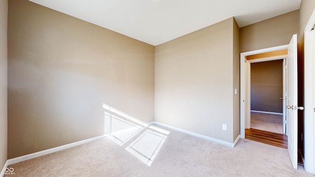 unfurnished room with light colored carpet