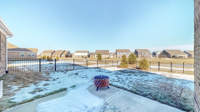 yard covered in snow featuring an outdoor fire pit