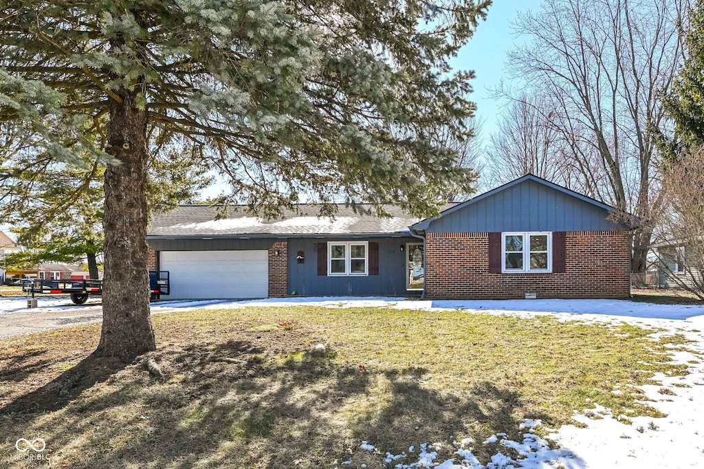 ranch-style home featuring a garage and a front lawn