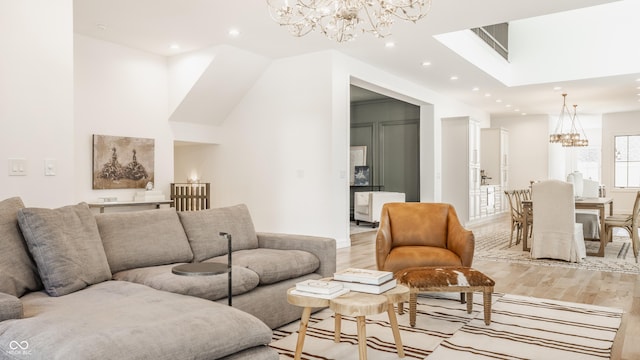 living room featuring an inviting chandelier and light hardwood / wood-style floors