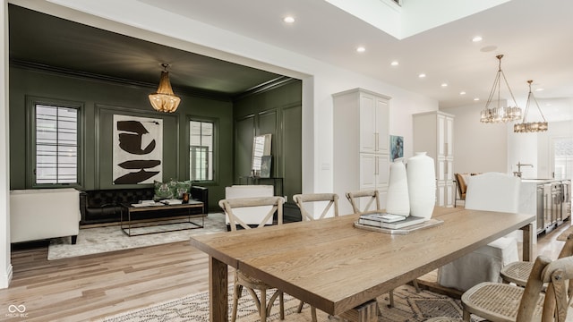 dining room featuring sink and light wood-type flooring