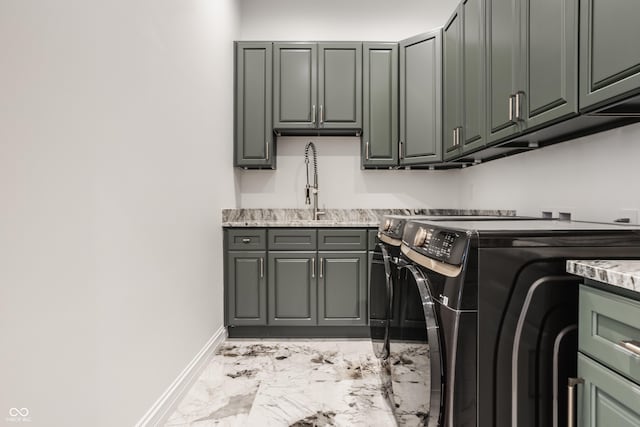 laundry area featuring cabinets, sink, and washing machine and clothes dryer