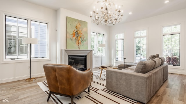 living area featuring an inviting chandelier and light wood-type flooring