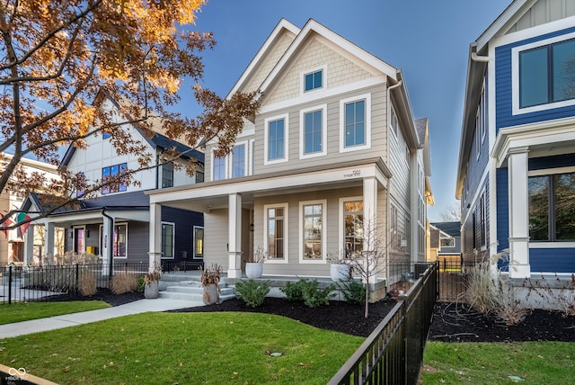 craftsman-style house with covered porch and a front lawn